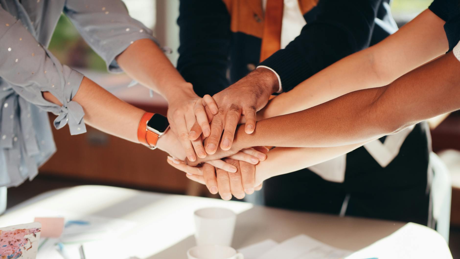people stacking hands together